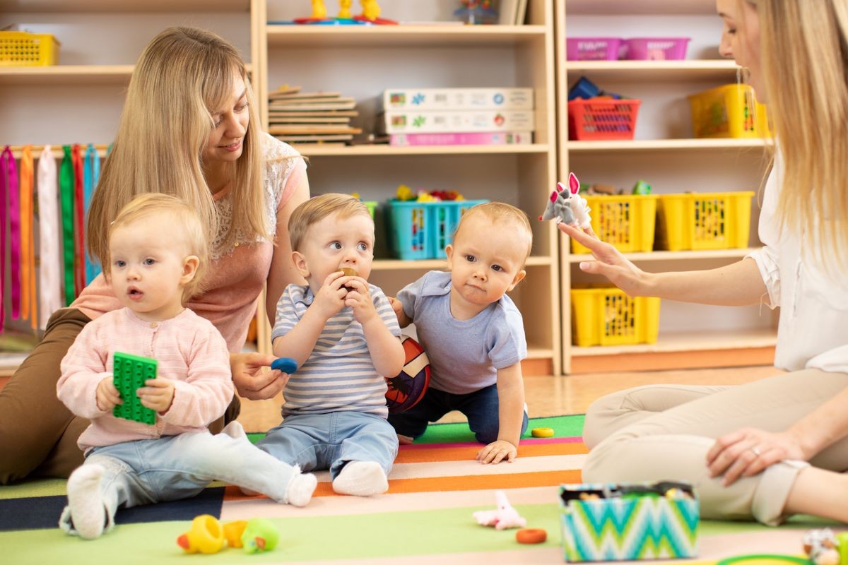 Babies is playing in nursery. Children in the day care center. Fun in the children's playroom